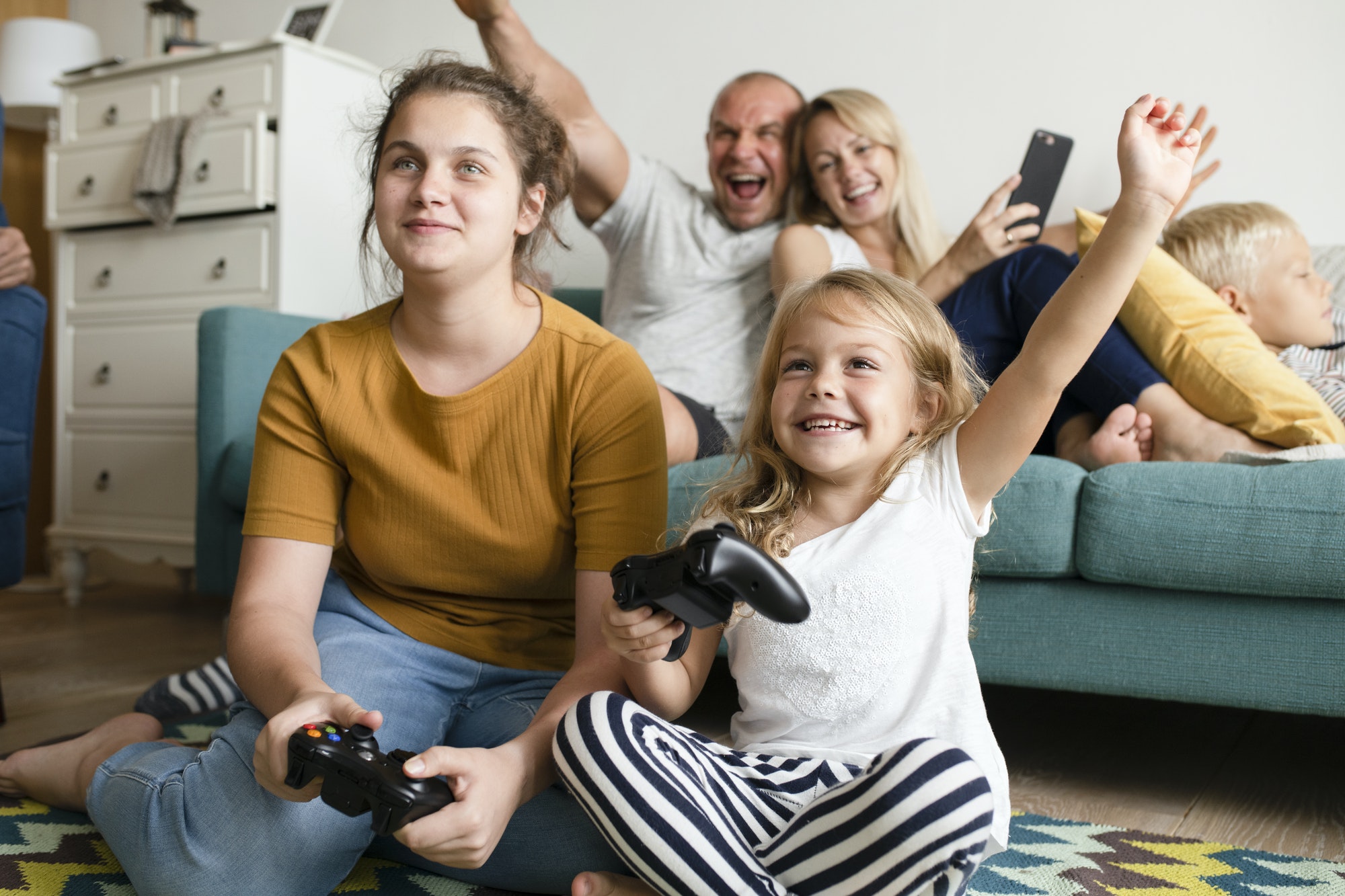 Sisters playing a video game on the floor